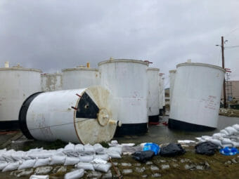 White fuel tanks, some tilted and one tipped over completely