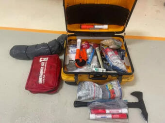 An open Pelican case filled with emergency supplies