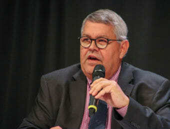 Charlie Pierce speaks into a microphone