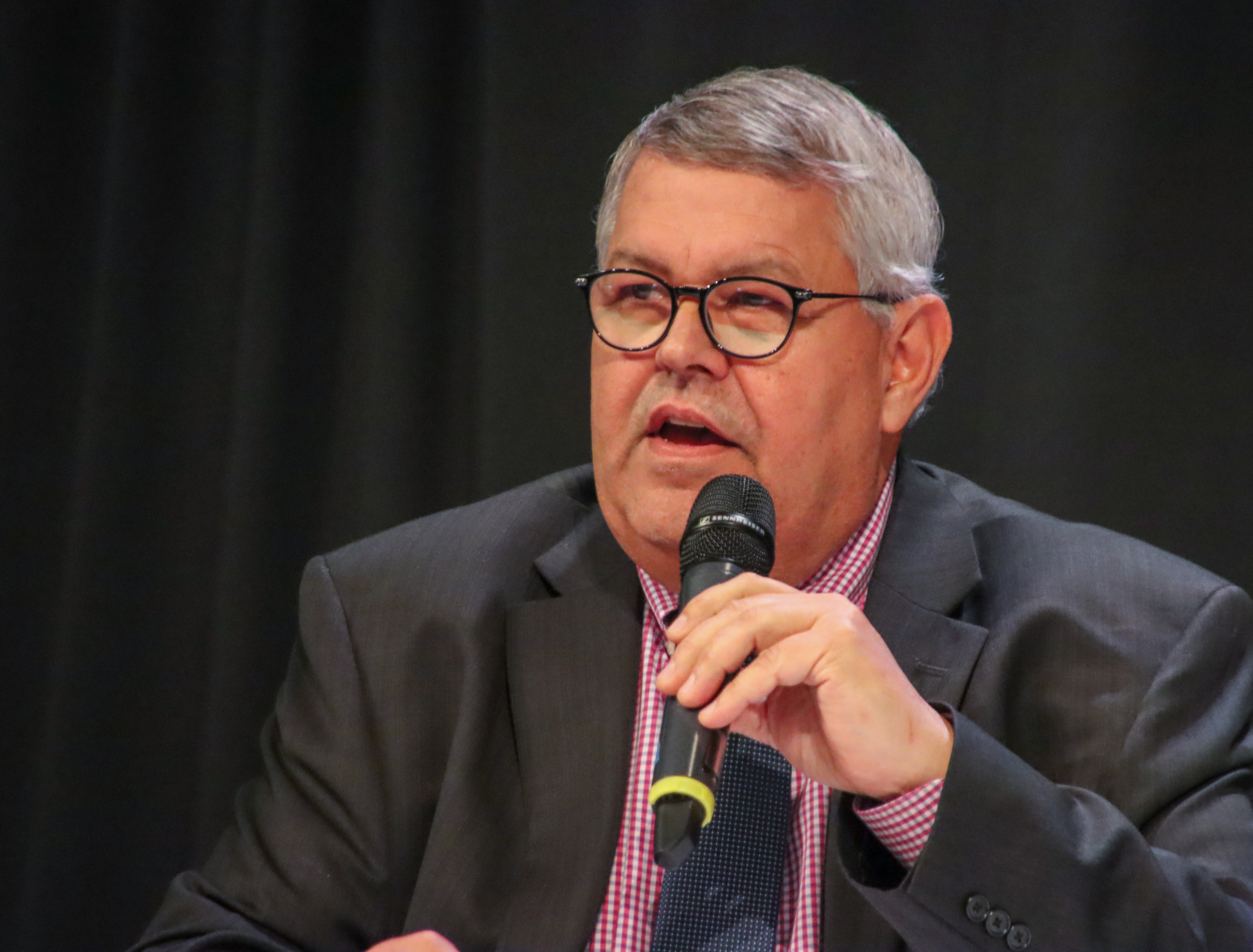 Charlie Pierce speaks into a microphone