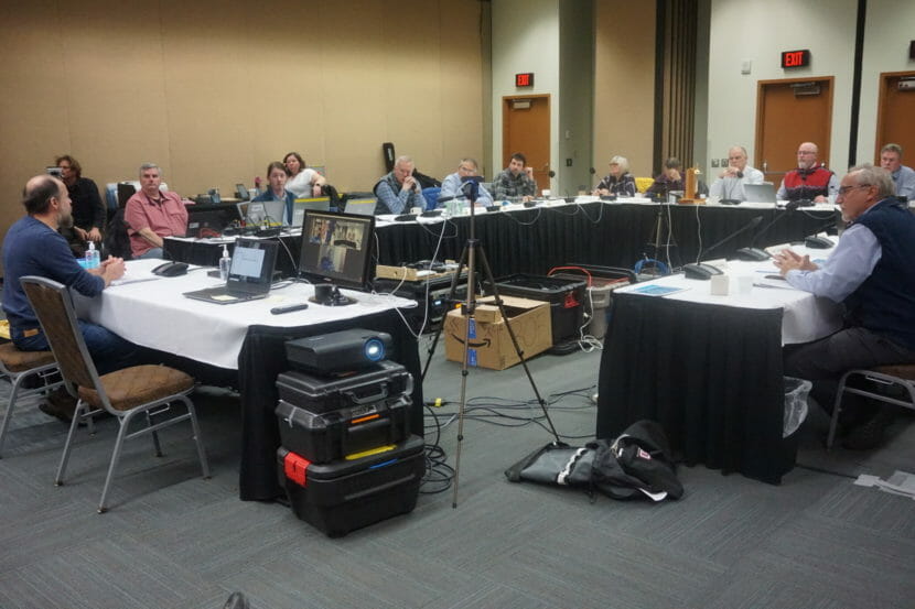 People seated around a table in a conference room