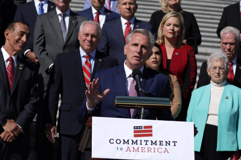 Kevin McCarthy speaks from behind a lectern with other lawmakers standing behind him