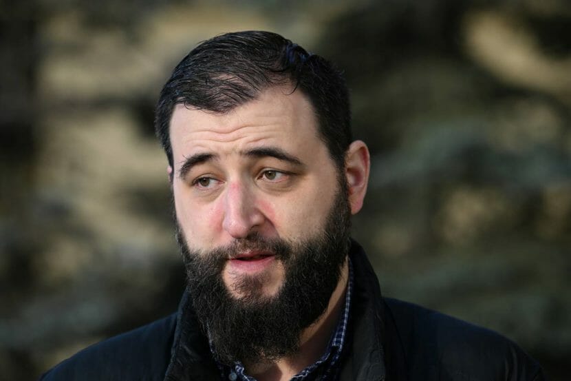 Photo portrait of a man with short hair and a full beard.