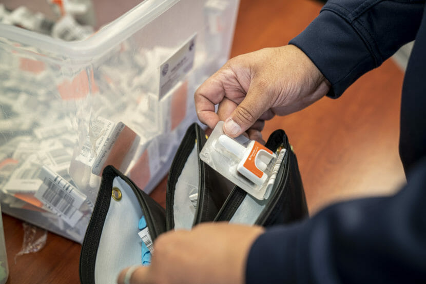Hands holding a naloxone inhaler