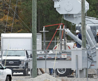 Trucks parked outside a power substation.