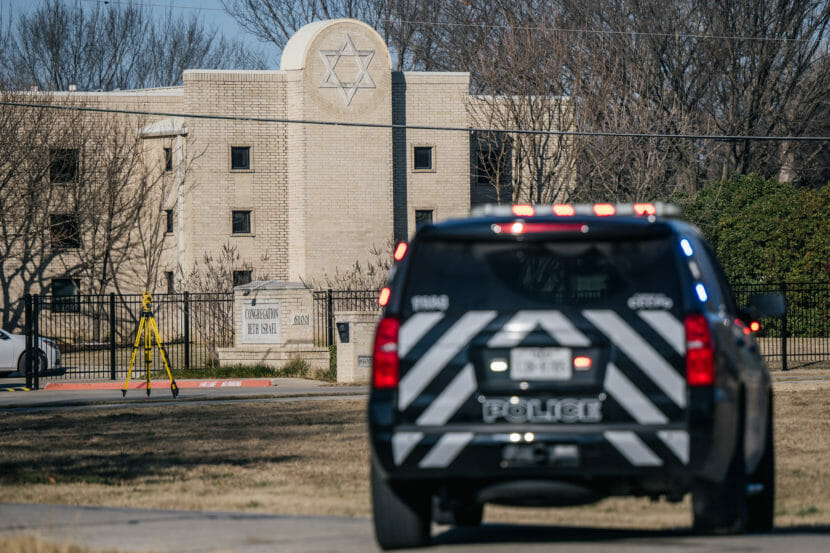 A police car parked outside a synagogue
