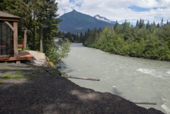 The Mendenhall River eroded about 50 feet of bank in just a few hours, stopping barely short of a house on River Drive in Juneau, Alaska following a glacial outburst flood on Saturday August 5th, 2023. (Mikko Wilson / KTOO)