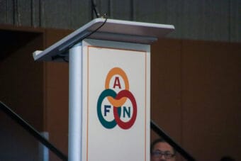 A podium with the letters AFN on its front stands on a stage.