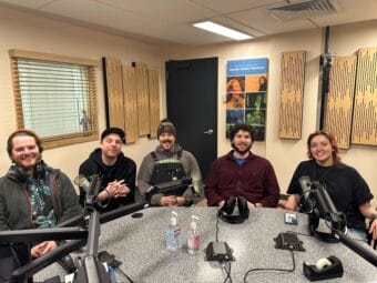 The Rain Dogs with The Crystal Saloon's David Elrod seated at the microphones. (From left to right: Keenan, David, Jacob, Avery, Anna) on Juneau Afternoon Thu, Feb. 6, 2025. (Bostin Christopher/KTOO)