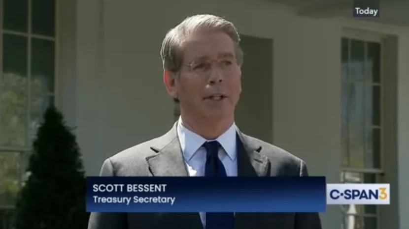 A man talks to reporters outside the White House