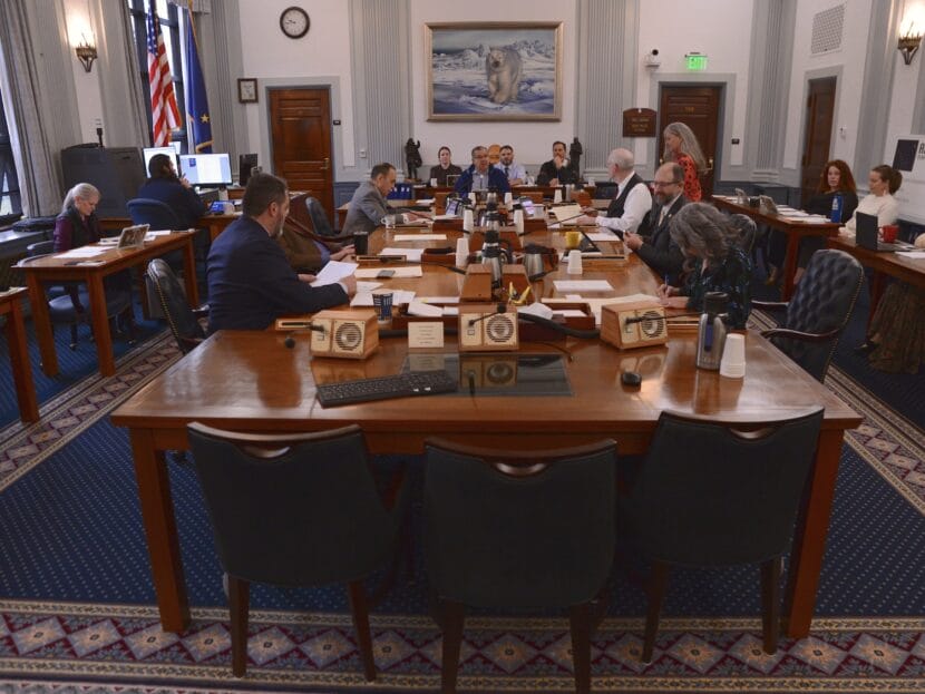 a committee room with legislators and staff