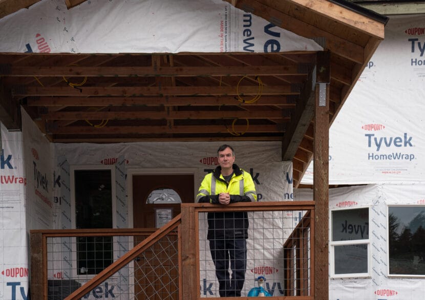 Samuel Hatch, a new plaintiff in the case, stands on the porch of his home on Meander Way. (Photo by Alix Soliman/KTOO)