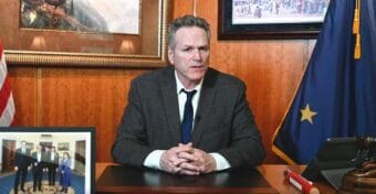 a man on a screen in a suit