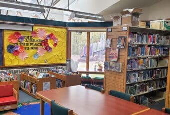 The inside of a small library that is packed with books.