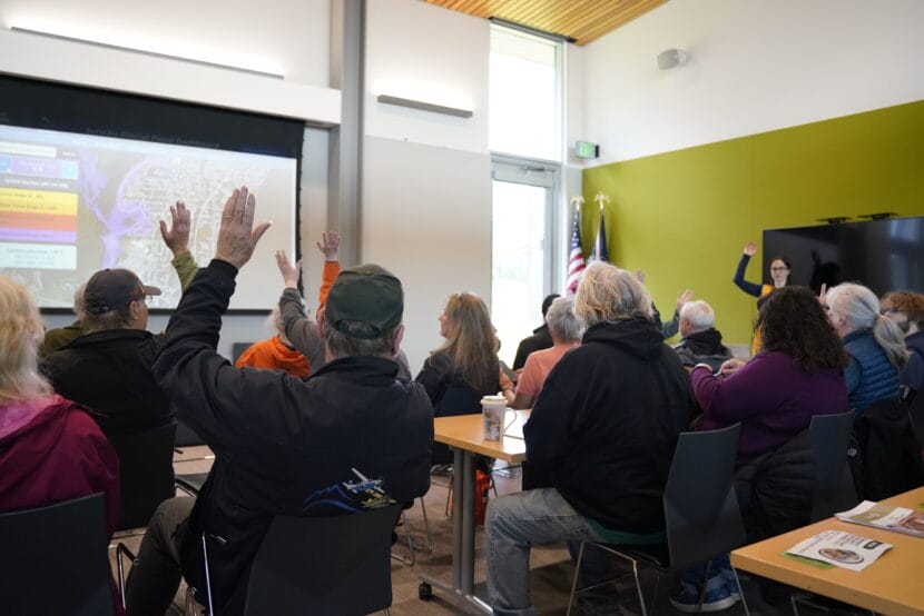 Residents who already have NFIP insurance raise their hands at the flood preparedness workshop on June 7, 2025. (Photo by Alix Soliman/KTOO)
