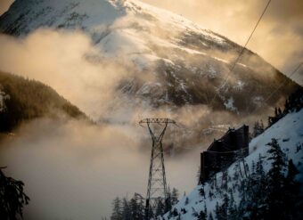 A tower and avalanche diversion wall on the Snettisham transmission line. (Photo courtesy of Mike Janes/AEL&P)