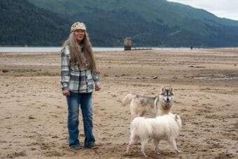 woman with dogs on beach