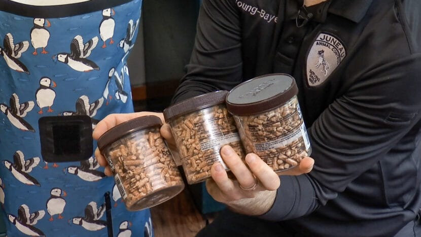 Animal Control Officer Thomas Young-Bayer holds jars full of cat litter as part of his emergency go-bag for his pets on July 2, 2025. (Photo by Mikko Wilson/KTOO)
