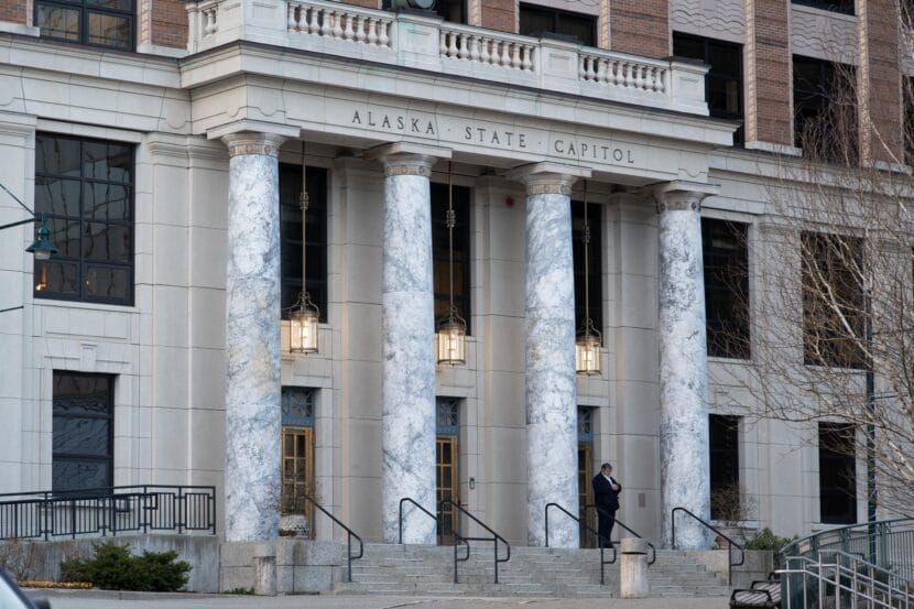 A legislative staffer waits outside the Alaska State Capitol in Juneau on March 20, 2025.