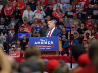 Former President Donald Trump speaks into a microphone at a pdoium