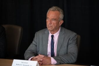 A man in a suit attends a press briefing