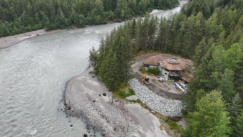 The Habegers build a berm around their house on View Drive on July 22, 2025. (Photo by Clarise Larson/KTOO)