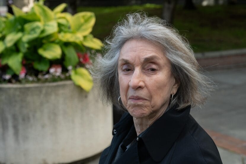 A woman in a black coat. 