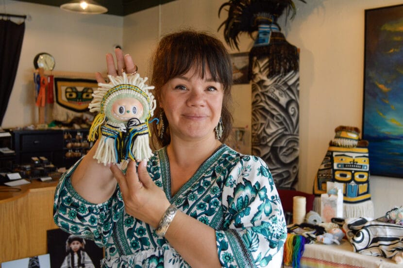Master weaver Lily Hope holds up a Labubu decked out in Ravenstail weaving on Sept. 12, 2025. (Photo by Yvonne Krumrey/KTOO)