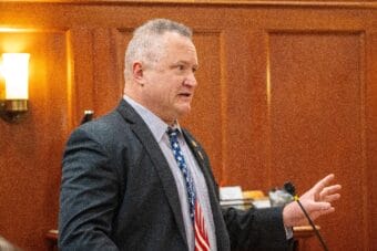Man speaking in legislative chamber