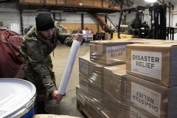 Alaska Organized Militia personnel, assigned to Task Force Bethel, prepare relief supplies for distribution to nearby villages during post-storm recovery efforts for Operation Halong Response at Bethel, Alaska on Nov 19, 2025.