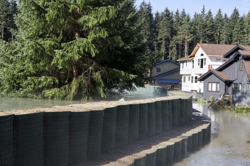 Floodwater seeps through HESCO barriers on Meander way during the glacial outburst flood on Wednesday, Aug. 13, 2025. (Photo by Clarise Larson/KTOO)