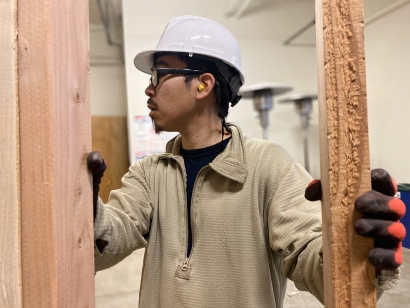 Reggie Paul of Kipnuk holds frame in Alaska Works Partnership construction workshop in Mountain View.