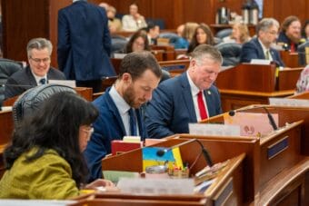 Lawmakers including Rep. Genevieve Mina, D-Anchorage, Rep. Zack Fields, D-Anchorage and Rep. Chuck Kopp, R-Anchorage, sit in the House chamber in the Alaska State Capitol in Juneau on Jan. 20, 2026.