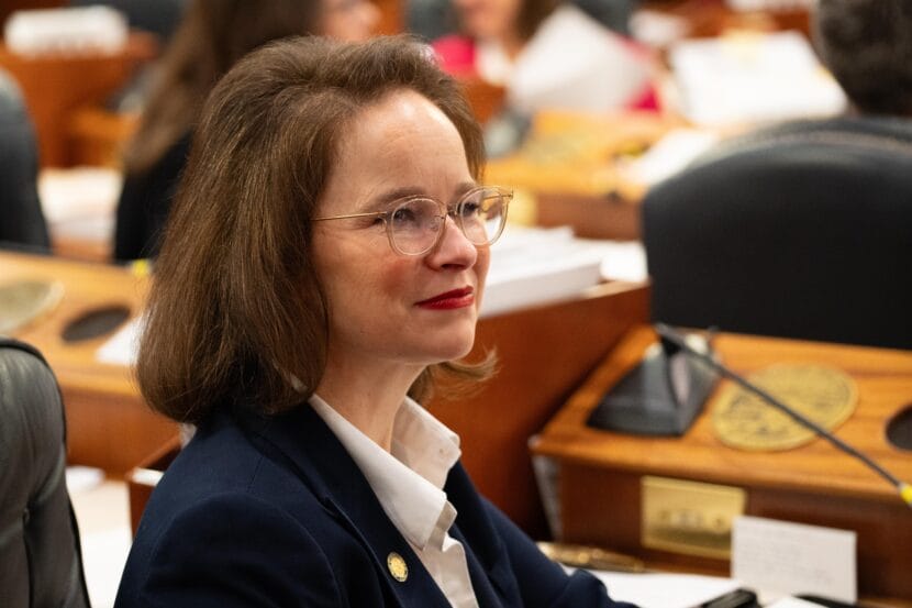 a portrait of a woman in a meeting room