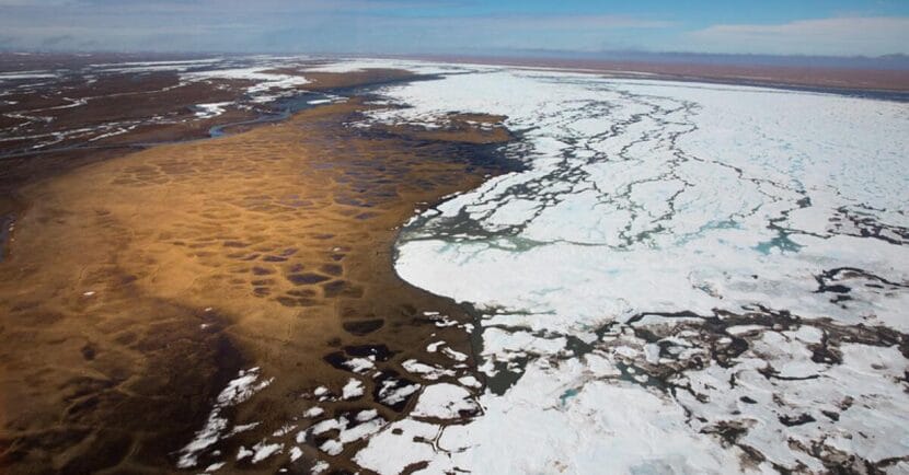 A tundra landscape half covered in ice