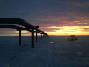 A pipeline stretching toward a sunset