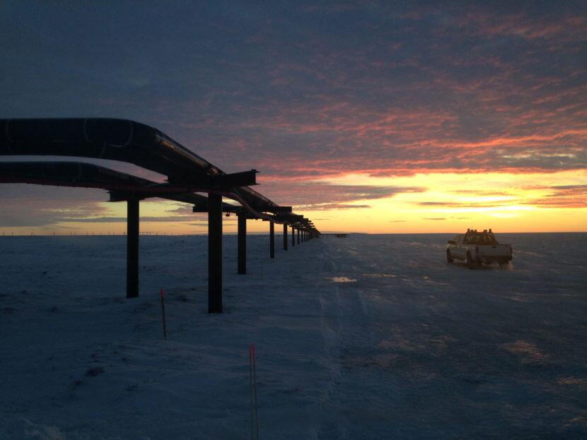 A pipeline stretching toward a sunset