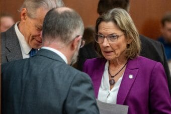 Sen. Cathy Giessel, an Anchorage Republican who carried House Bill 78 in the upper chamber, huddles with other senators during a debate on Tuesday, April 28, 2026.