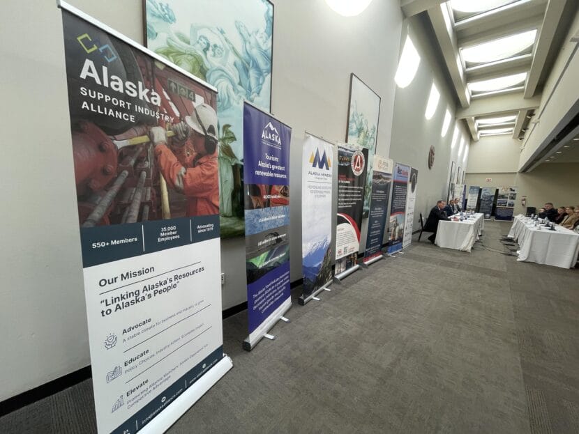 People in a room with industry posters
