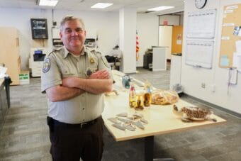 Chris Andrews with some samples of confiscated goods in his office at the Ted Steven Anchorage International Airport on June 4, 2026. Andrews says he never knows what he's going to find next.