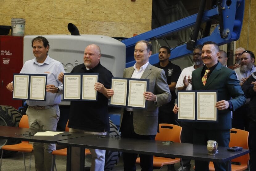 From left, Alaska Petroleum Joint Crafts Council President Joey Merrick, Fairbanks Building and Construction Trades Council President Lake Williams, 8 Star Alaska LLC Co-President Rex Canon and Building and Construction Trades Council of Southcentral Alaska President Bronson Frye pose with signed copies of an agreement to maximize the use of in-state labor on a gas pipeline project at an event in Chugiak on Thursday, June 11, 2026.